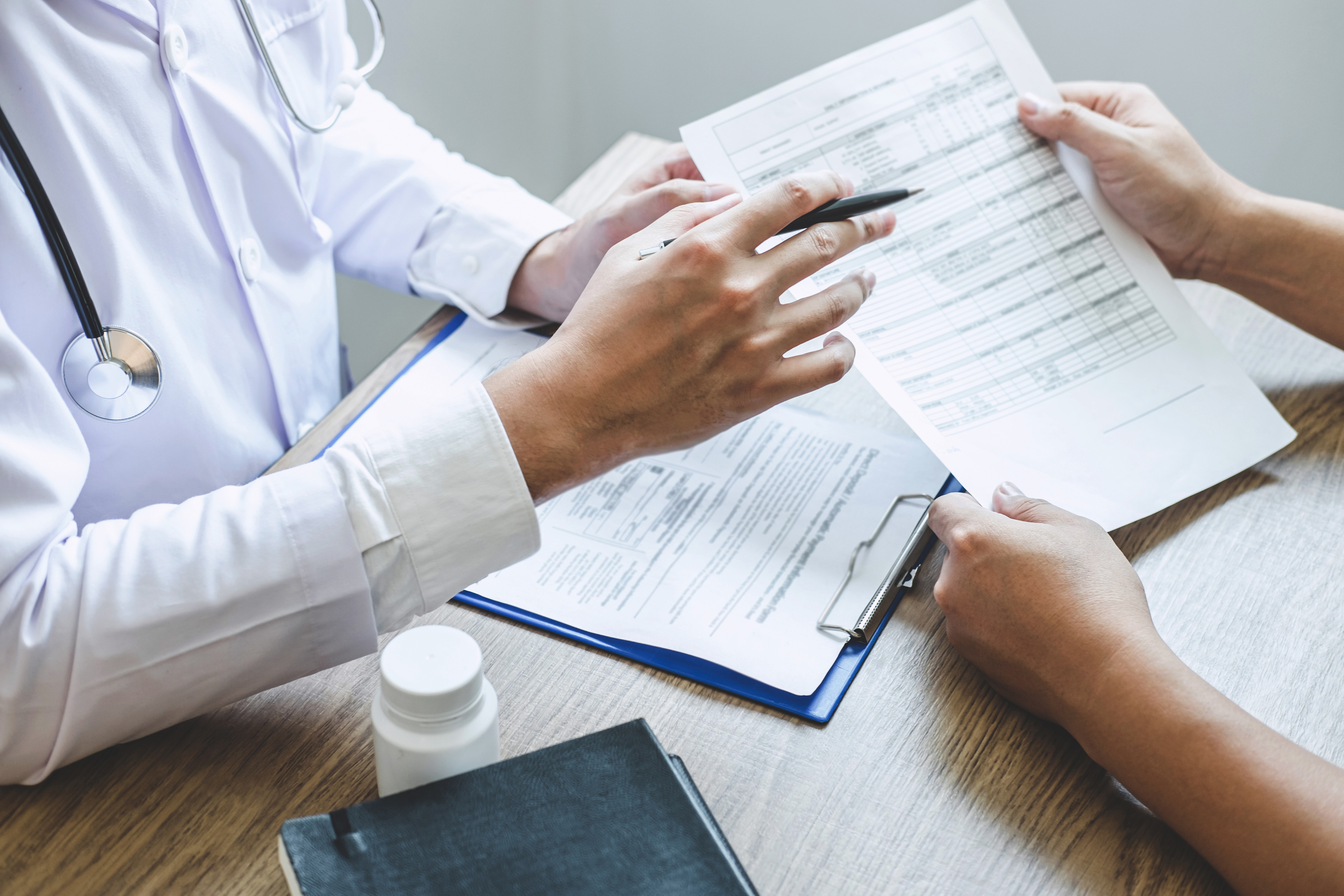 Professional Doctor in White Uniform Gown Coat and Patient